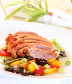 a_duck_breast_roasted_over_salad